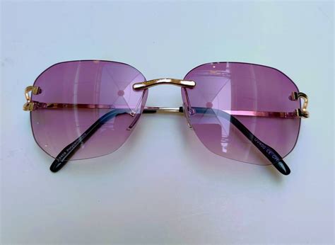 sunglasses gold frame purple lenses.